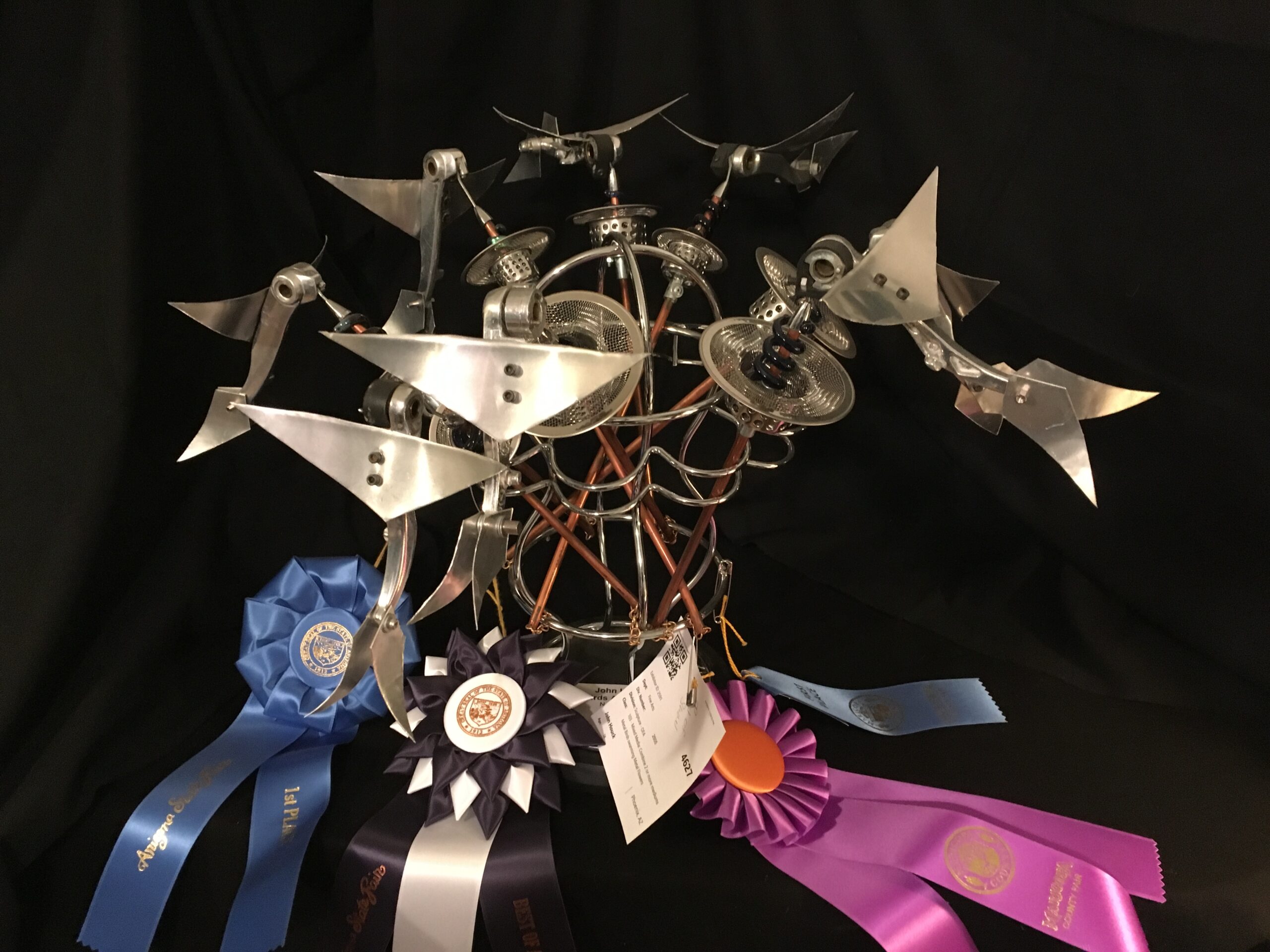 Birds at Flowers was constructed between spring 2017 and fall 2018, in Phoenix AZ. Using recycled bike parts, and common household items, this piece captured the best of show at both the 2018 Arizona State Fair, Fine Arts, Sculpture, Metal art, and the 2019 Maricopa County Fair, Fine Arts, Sculpture, Mixed metal.